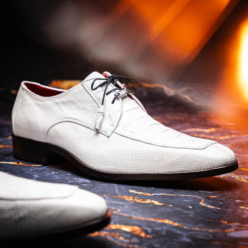 The Merida White by Marco Di Milano: luxury white textured leather caiman derby shoes with black soles, black laces, and brown leather outsoles, displayed with one shoe on its side.