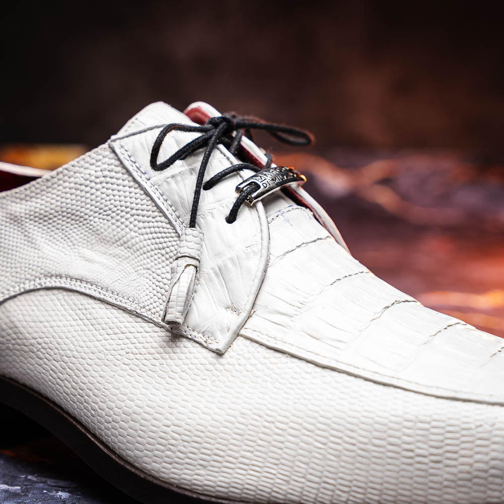 The Merida White by Marco Di Milano: luxury white textured leather caiman derby shoes with black soles, black laces, and brown leather outsoles, displayed with one shoe on its side.
