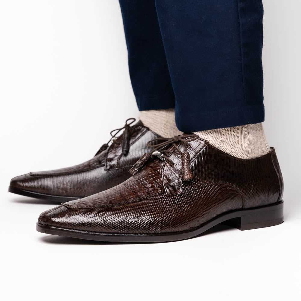 The Merida Brown by Marco Di Milano: a pair of dark brown, textured caiman dress derby shoes with laces—one upright and the other on its side revealing the sole—ideal for those seeking genuine exotic luxury footwear.
