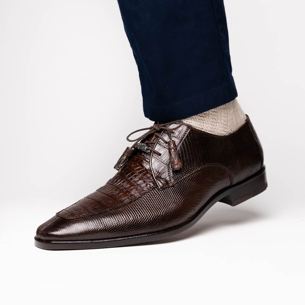 The Merida Brown by Marco Di Milano: a pair of dark brown, textured caiman dress derby shoes with laces—one upright and the other on its side revealing the sole—ideal for those seeking genuine exotic luxury footwear.