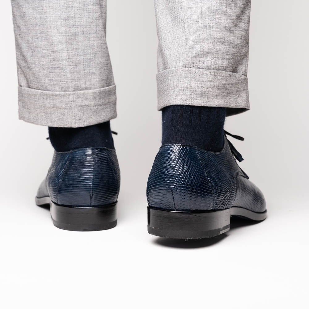 The Merida Navy by Marco Di Milano: blue textured leather caiman dress derby shoes, shown upright and on their side to highlight the sole and striking red inner lining—an elegant expression of luxury footwear.