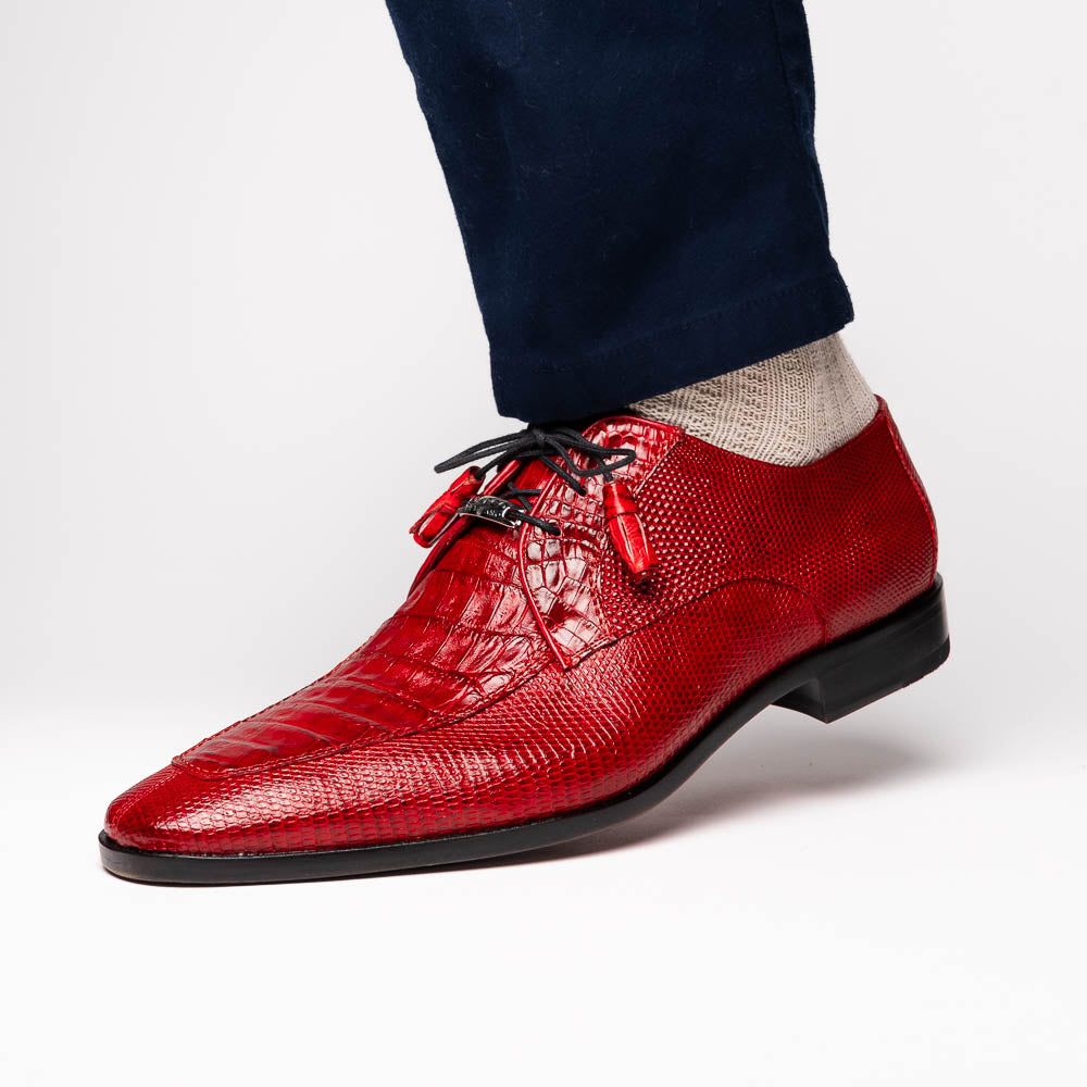 The Merida Red by Marco Di Milano are red textured leather luxury dress shoes with black laces and red tassels, shown both upright and sideways to highlight their hand-painted sole finishes.