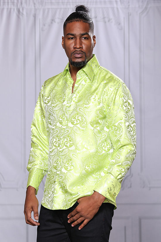 A man stands before a light paneled backdrop, wearing the Manzini MANZINI MZT-100 Paisley Long Sleeve Satin Mint Shirt with links and black pants.