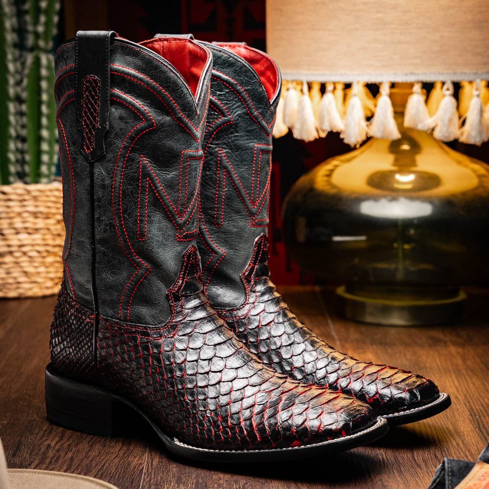 The Missouri BlackCherry by Marco Di Milano are handcrafted men's cowboy boots in black and red with a striking snakeskin texture, decorative stitching, and the sole stamped "Marco Di Milano." One boot is shown upright; the other displays the sole.