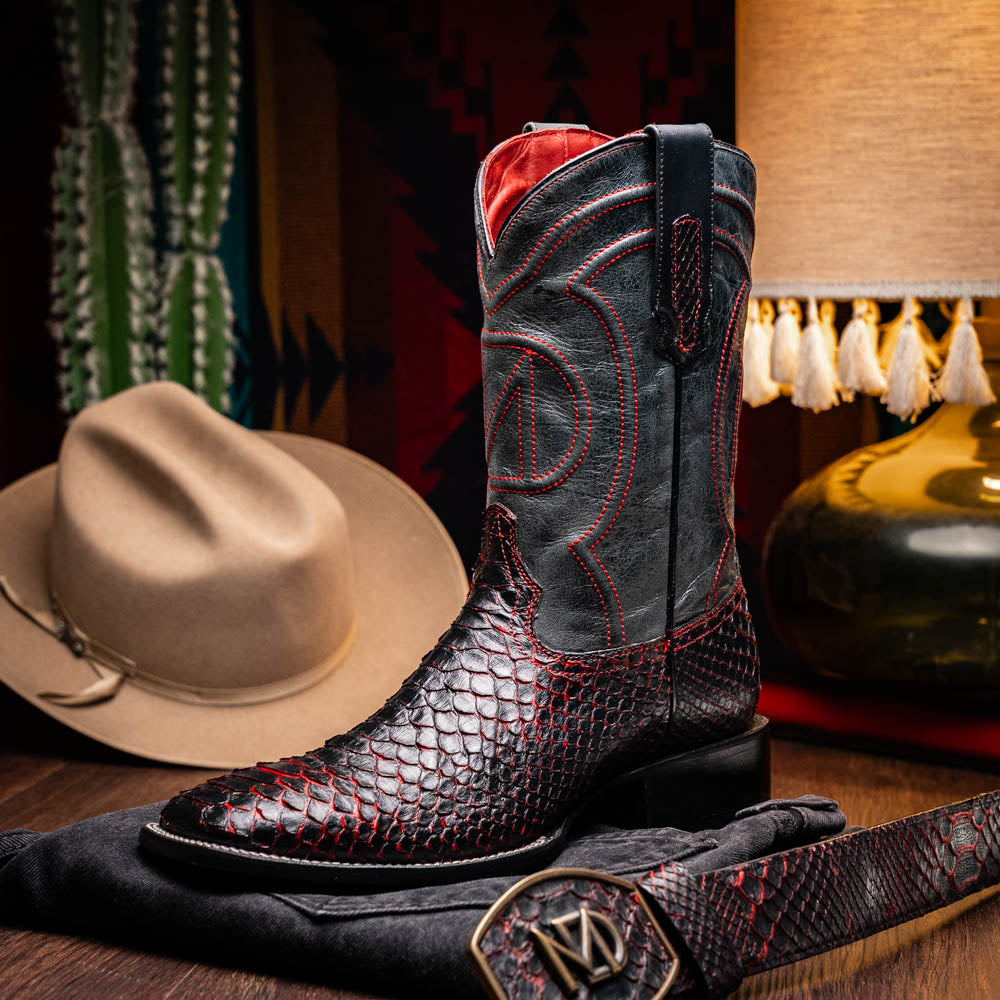 The Missouri BlackCherry by Marco Di Milano are handcrafted men's cowboy boots in black and red with a striking snakeskin texture, decorative stitching, and the sole stamped "Marco Di Milano." One boot is shown upright; the other displays the sole.