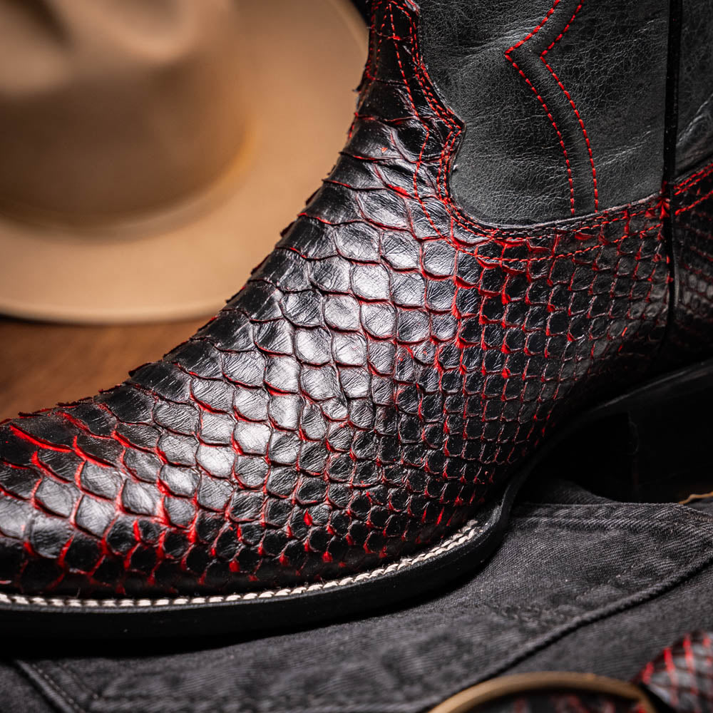 The Missouri BlackCherry by Marco Di Milano are handcrafted men's cowboy boots in black and red with a striking snakeskin texture, decorative stitching, and the sole stamped "Marco Di Milano." One boot is shown upright; the other displays the sole.
