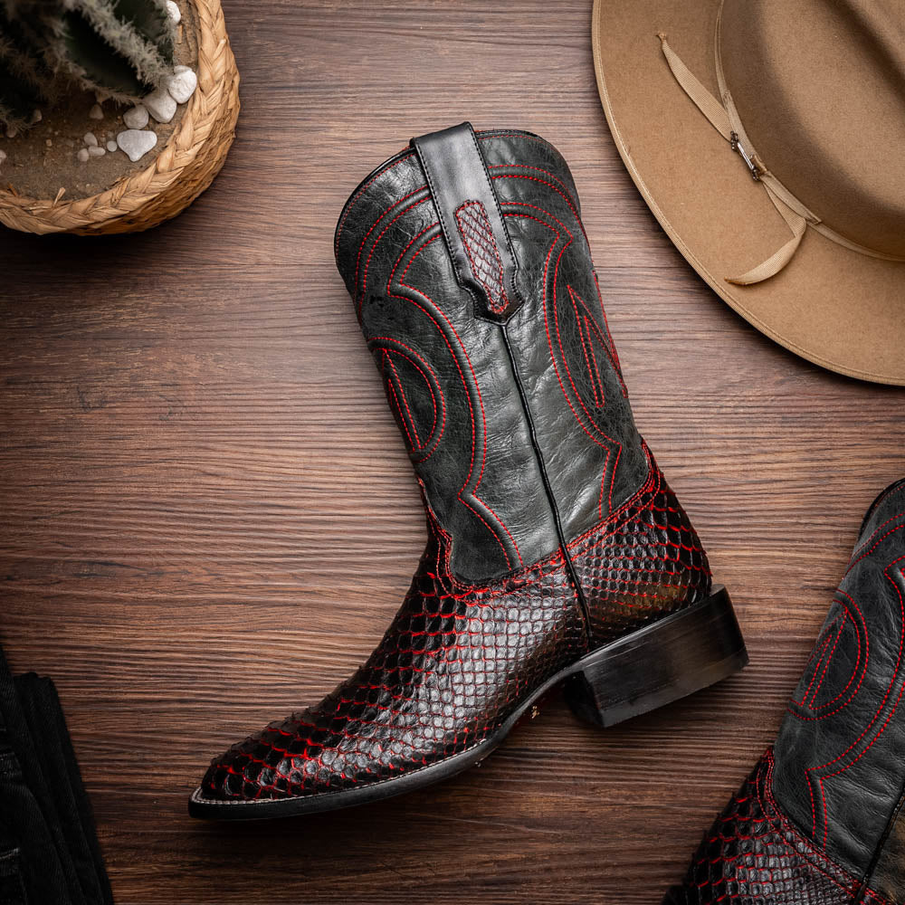 The Missouri BlackCherry by Marco Di Milano are handcrafted men's cowboy boots in black and red with a striking snakeskin texture, decorative stitching, and the sole stamped "Marco Di Milano." One boot is shown upright; the other displays the sole.