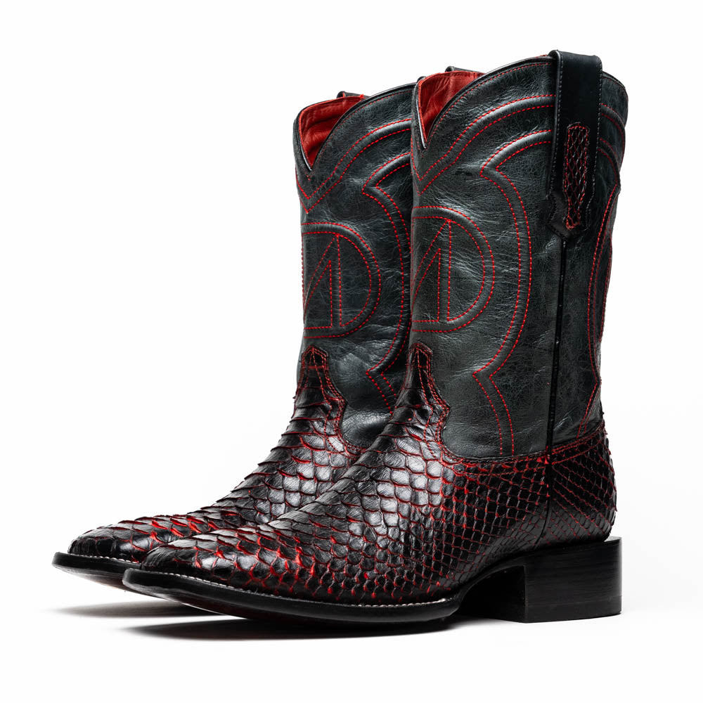 The Missouri BlackCherry by Marco Di Milano are handcrafted men's cowboy boots in black and red with a striking snakeskin texture, decorative stitching, and the sole stamped "Marco Di Milano." One boot is shown upright; the other displays the sole.