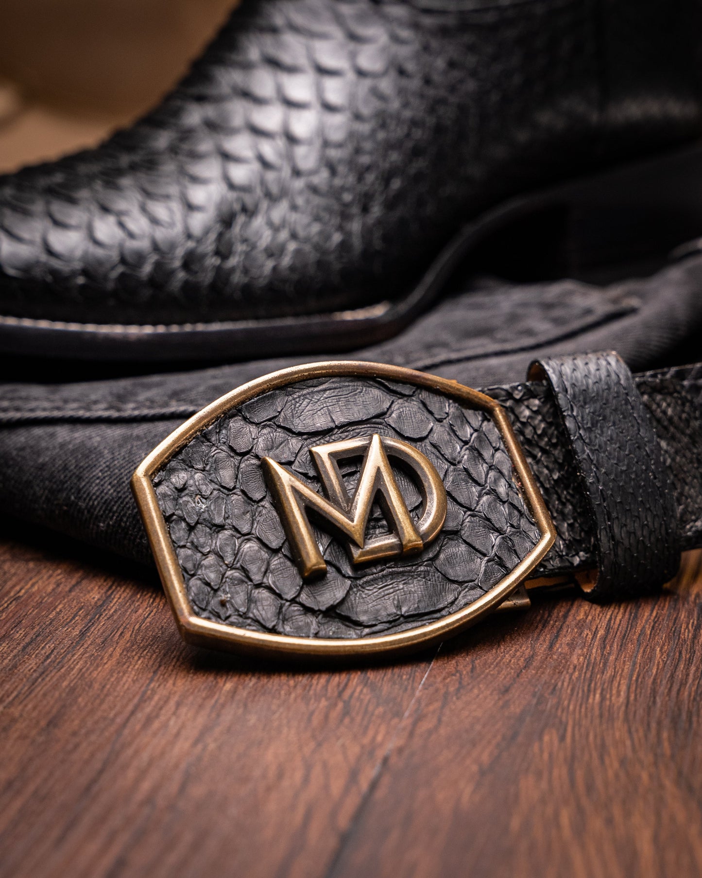 Missouri Black by Marco Di Milano: black, textured handcrafted men's boots with a red interior lining. One boot stands upright, the other shows the "MARCO DI MILANO" sole—exotic western boots for a bold statement.