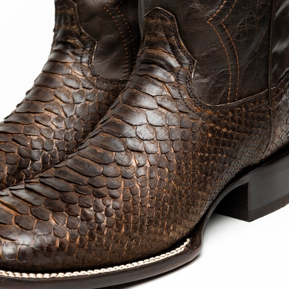 Missouri Brown by Marco Di Milano: a pair of handcrafted men's cowboy boots in genuine brown python skin, one standing upright and one displaying the branded sole, for an exotic western look.