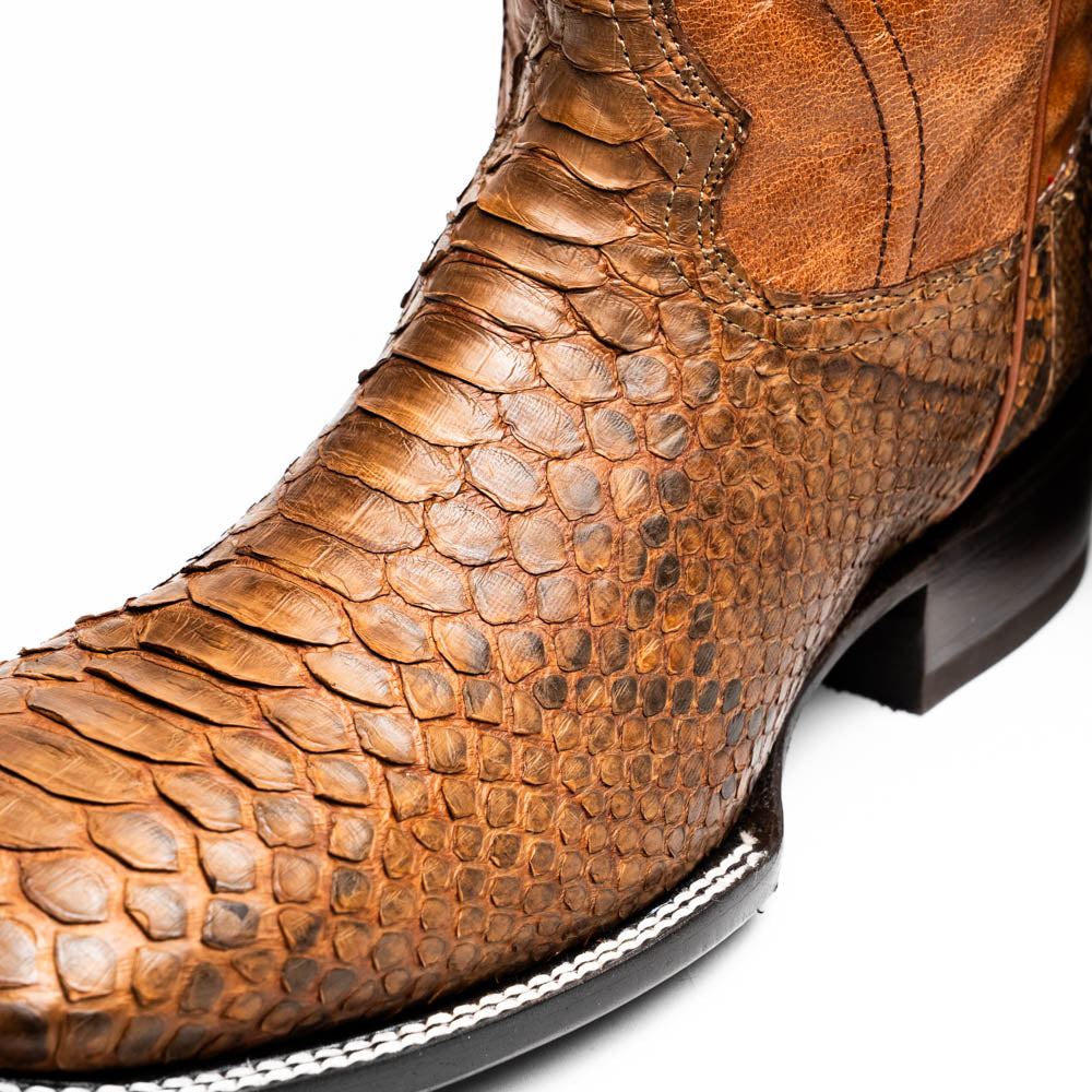The Missouri Cognac boots by Marco Di Milano showcase classic style and premium detail with brown handcrafted leather, a textured snakeskin pattern, and distinctive branding on the sole.