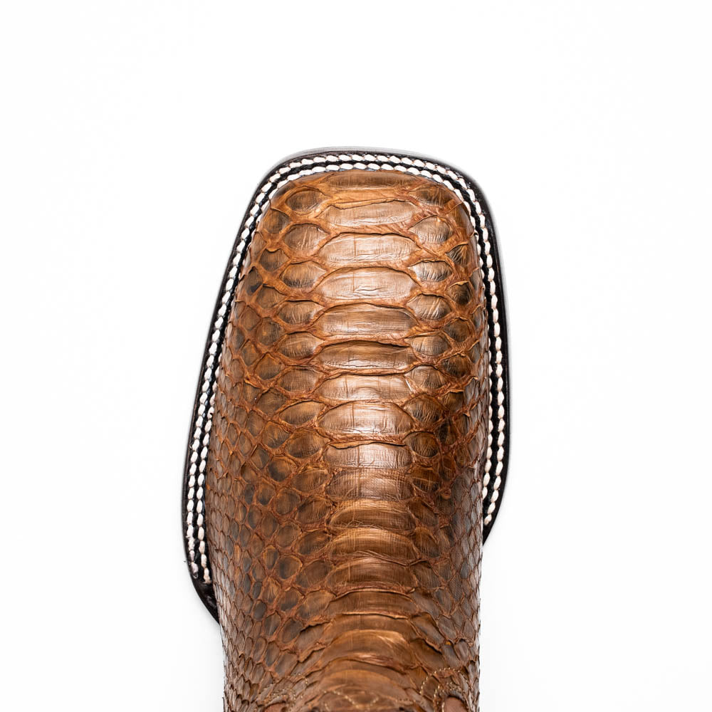 The Missouri Cognac boots by Marco Di Milano showcase classic style and premium detail with brown handcrafted leather, a textured snakeskin pattern, and distinctive branding on the sole.