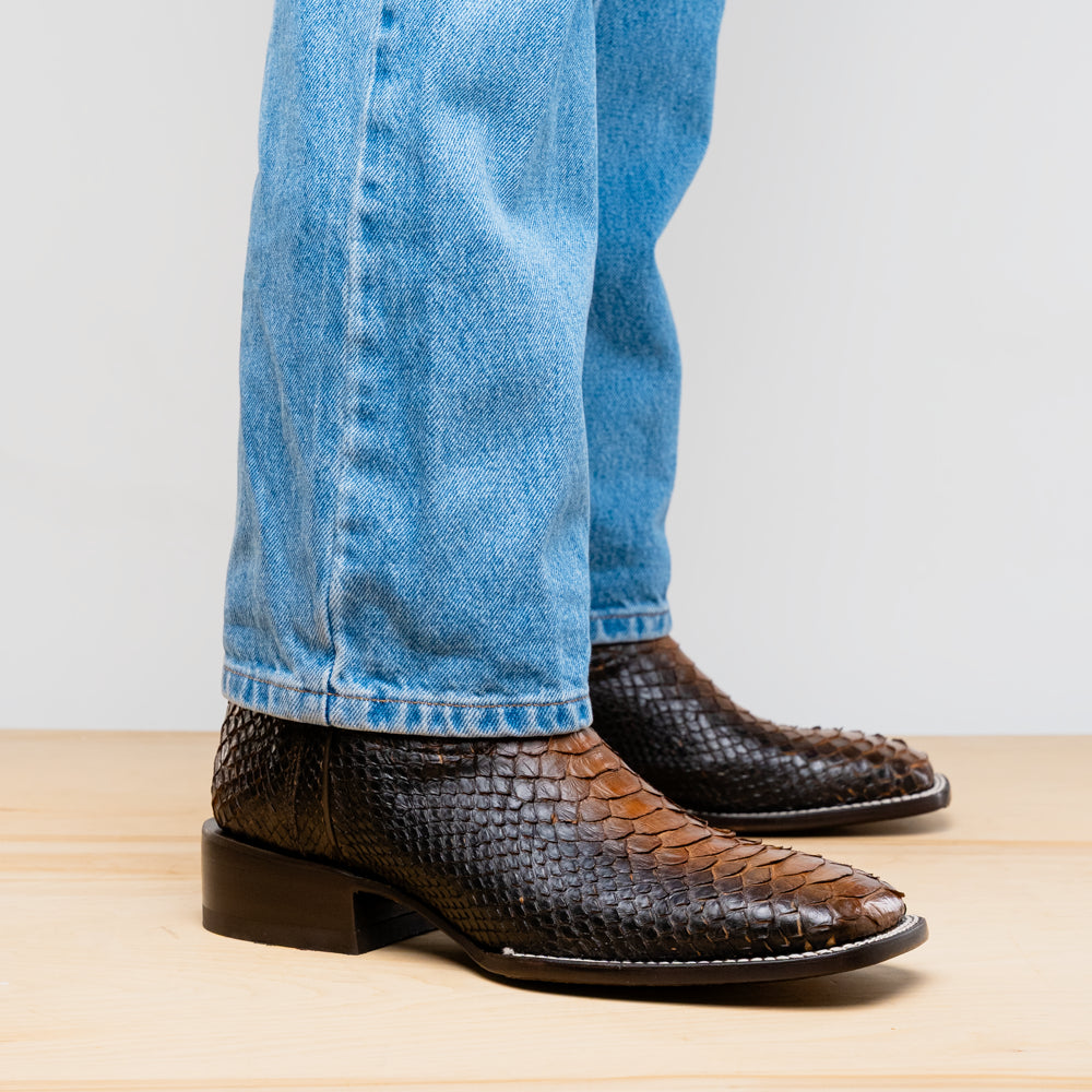 The Missouri Lisboa by Marco Di Milano offers men's cowboy boots with a textured snakeskin-style lower section, smooth upper, and a branded sole for a unique, handcrafted look.