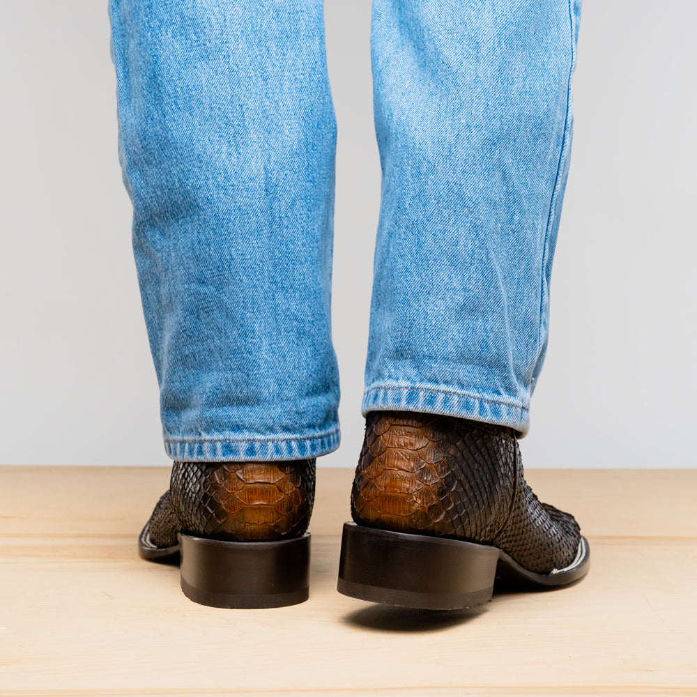 The Missouri Lisboa by Marco Di Milano offers men's cowboy boots with a textured snakeskin-style lower section, smooth upper, and a branded sole for a unique, handcrafted look.