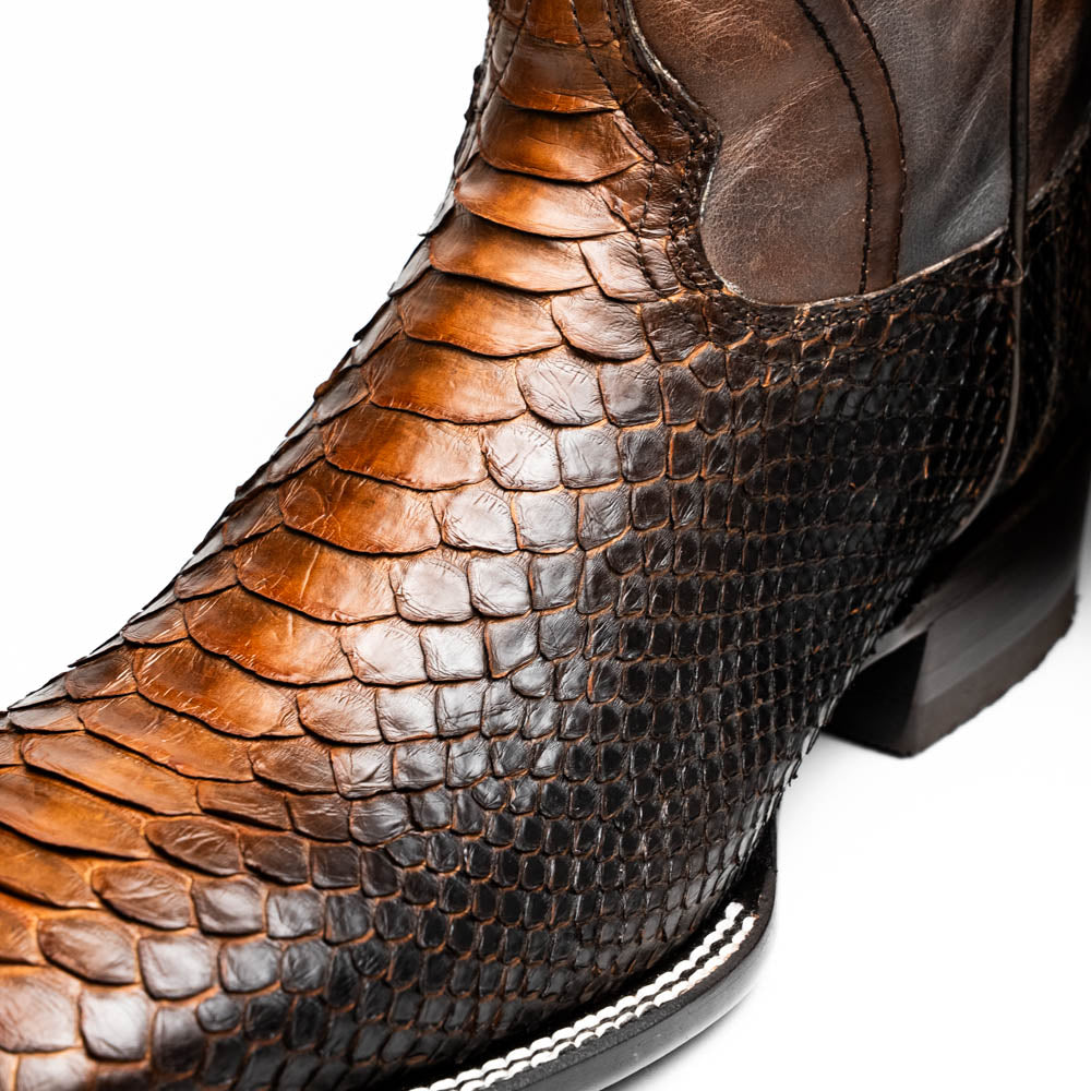 The Missouri Lisboa by Marco Di Milano offers men's cowboy boots with a textured snakeskin-style lower section, smooth upper, and a branded sole for a unique, handcrafted look.