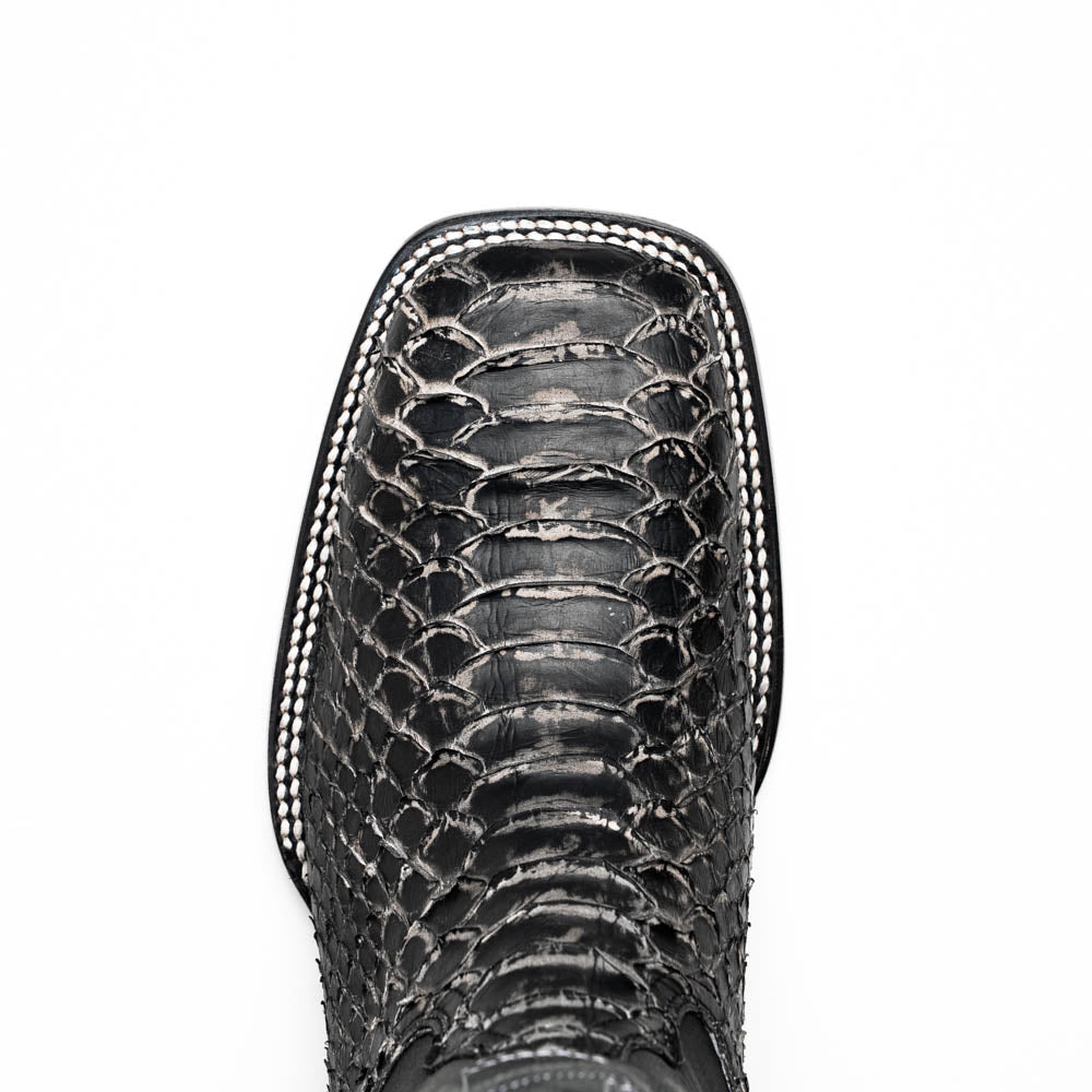 A pair of Missouri Stone White cowboy boots by Marco Di Milano, handcrafted in black textured python leather with branded soles, displayed on a white background.