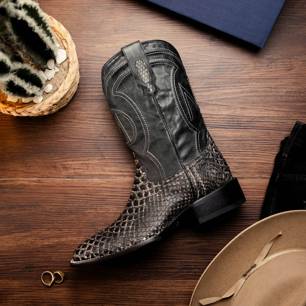 A pair of Missouri Stone White cowboy boots by Marco Di Milano, handcrafted in black textured python leather with branded soles, displayed on a white background.