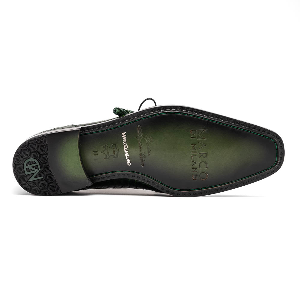 A pair of Moncalieri Green luxury shoes by Marco Di Milano, one upright with tied laces and the other on its side showing the sole—crocodile-patterned elegance at its finest.