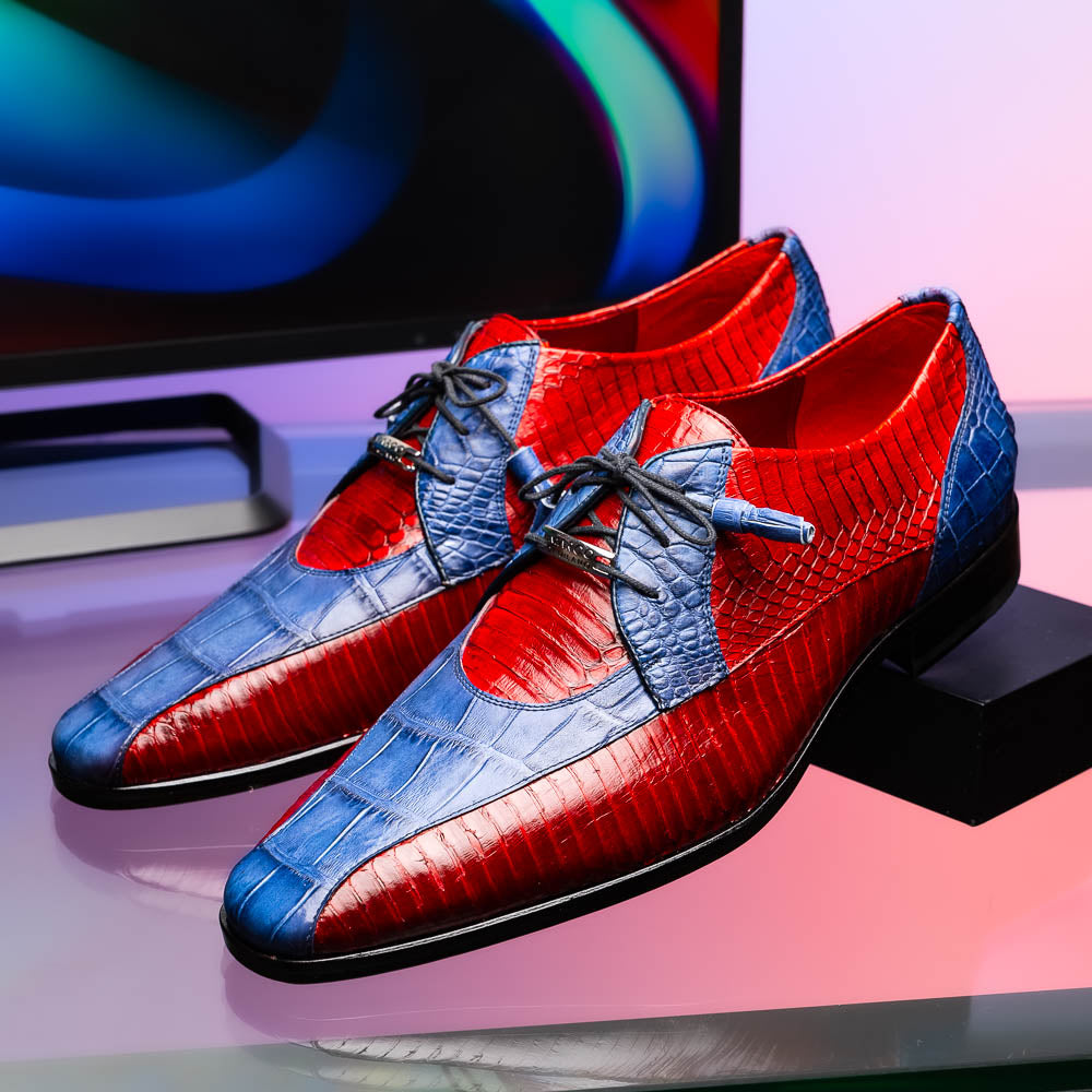 The Moncalieri Navy / Red by Marco Di Milano is a pair of men’s luxury shoes crafted from shiny red and blue crocodile leather with pointed toes, lace-up fronts, hand-painted finishes, and black soles.