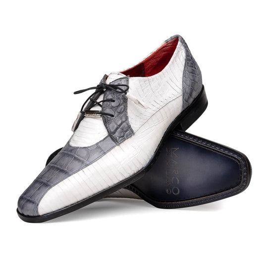 The Marco Di Milano Moncalieri Gray / White men's dress shoes feature a luxury white and grey crocodile pattern, black laces, and black soles, with one shoe stylishly propped against the other.