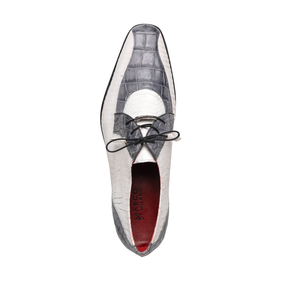 The Marco Di Milano Moncalieri Gray / White men's dress shoes feature a luxury white and grey crocodile pattern, black laces, and black soles, with one shoe stylishly propped against the other.