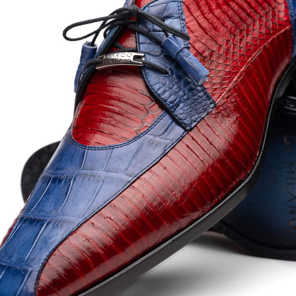 The Moncalieri Navy / Red by Marco Di Milano is a pair of men’s luxury shoes crafted from shiny red and blue crocodile leather with pointed toes, lace-up fronts, hand-painted finishes, and black soles.