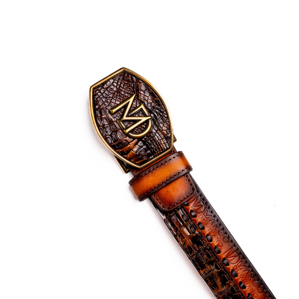 The Montana Belt Aged Brown by Marco Di Milano features aged brown leather with embossed patterns, metal studs, a bold gold MD monogram buckle, and the brand name on the strap for a sophisticated Western look.