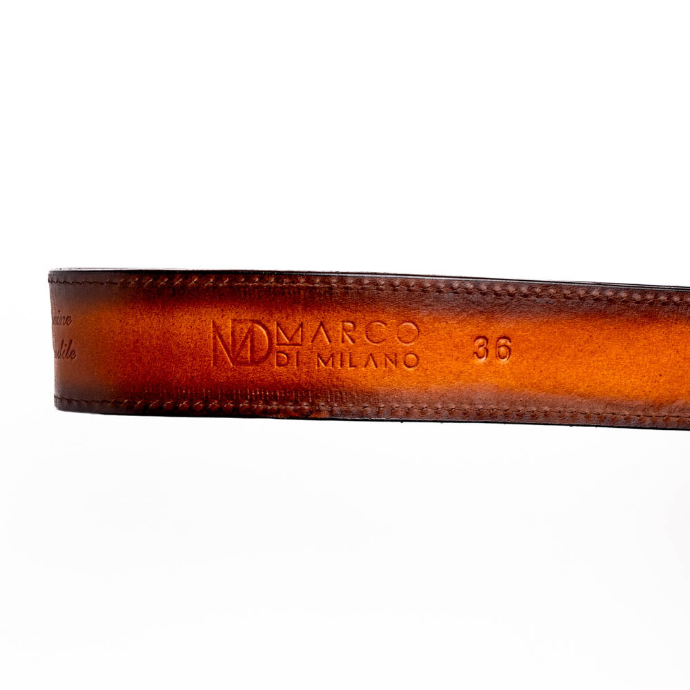 The Montana Belt Aged Brown by Marco Di Milano features aged brown leather with embossed patterns, metal studs, a bold gold MD monogram buckle, and the brand name on the strap for a sophisticated Western look.