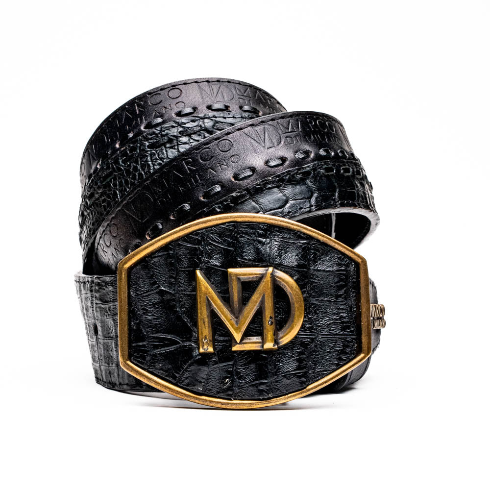The Marco Di Milano Montana Belt Black features handcrafted black textured leather and a large gold MD monogram buckle, elegantly coiled against a white background.