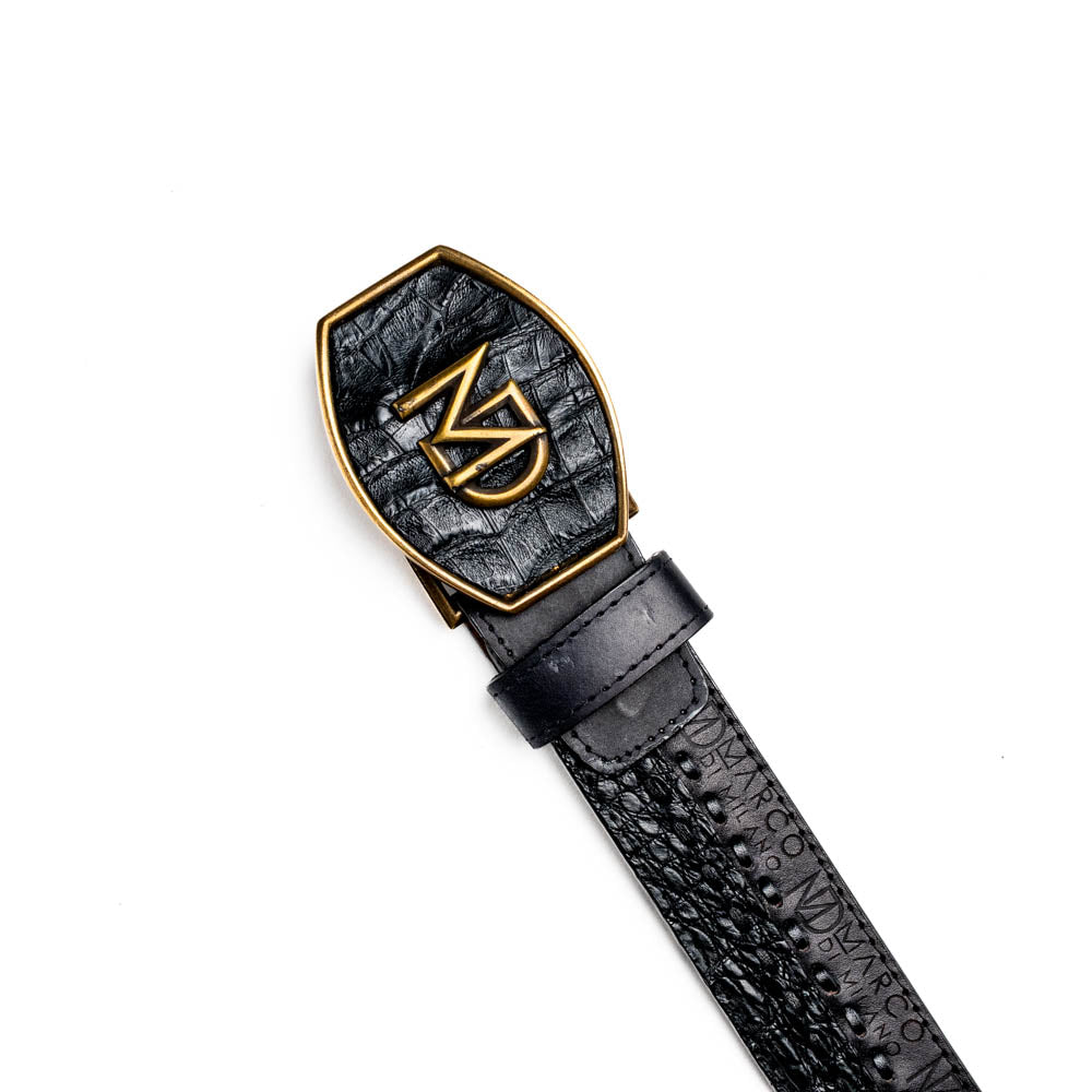 The Marco Di Milano Montana Belt Black features handcrafted black textured leather and a large gold MD monogram buckle, elegantly coiled against a white background.