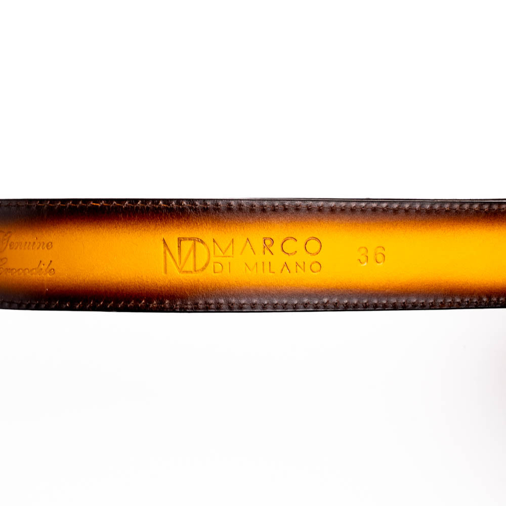The Montana Belt Mustard Brown by Marco Di Milano features a brown caiman crocodile texture, a bold gold "MD" buckle, and "MARCO DI MILANO" embossed on the side, reflecting the brand’s renowned craftsmanship.