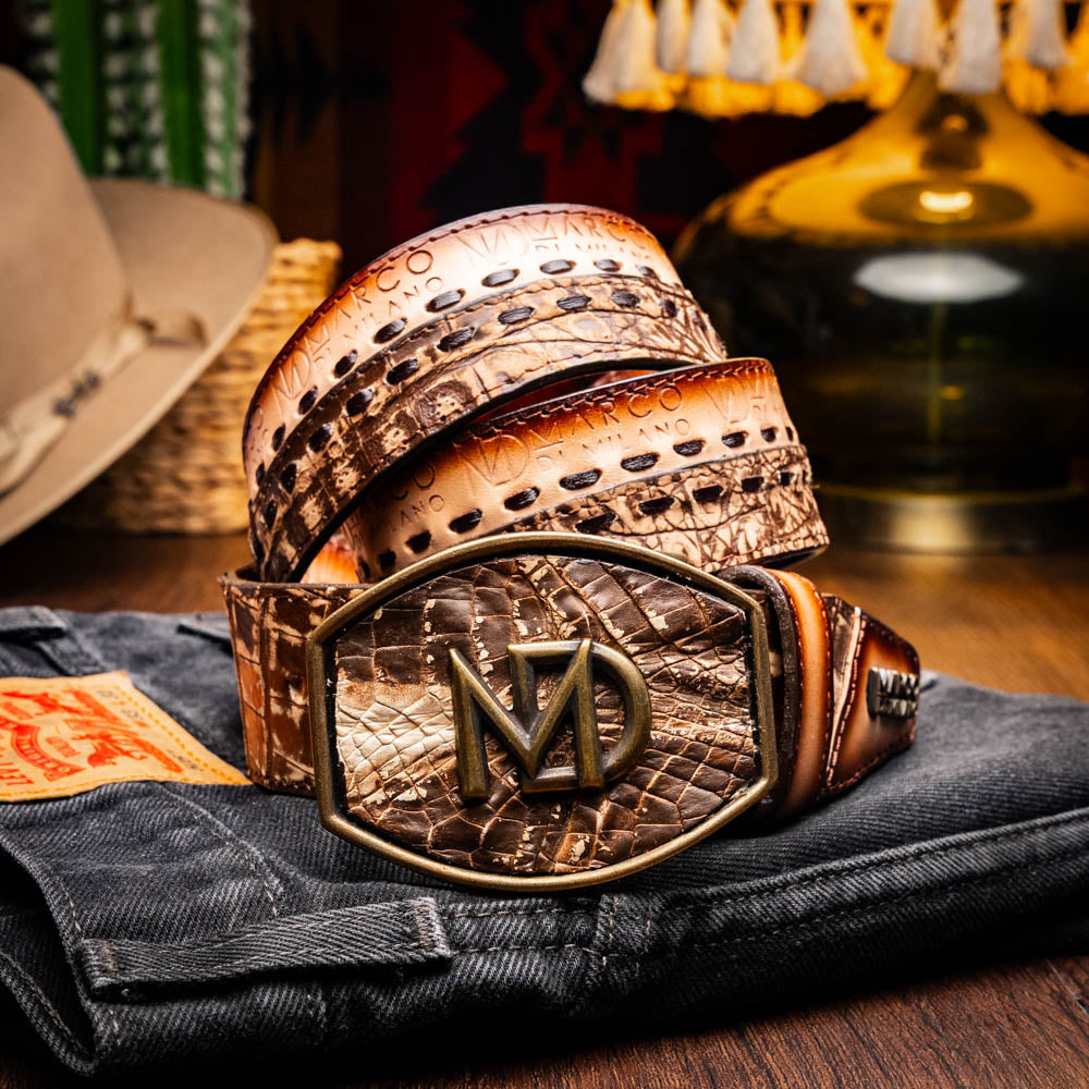 The Montana Belt Stone Brown by Marco Di Milano is a handcrafted western leather belt with a caiman crocodile pattern and a bold gold "MD" buckle.