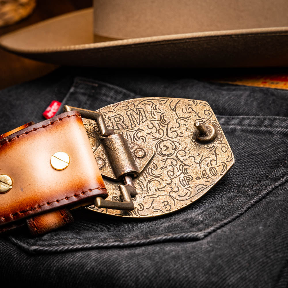 The Montana Belt Stone Brown by Marco Di Milano is a handcrafted western leather belt with a caiman crocodile pattern and a bold gold "MD" buckle.