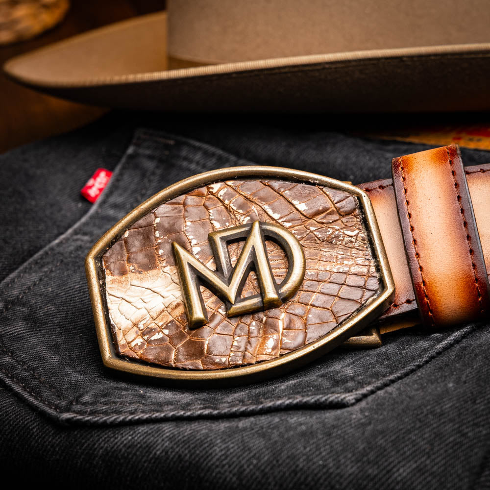 The Montana Belt Stone Brown by Marco Di Milano is a handcrafted western leather belt with a caiman crocodile pattern and a bold gold "MD" buckle.