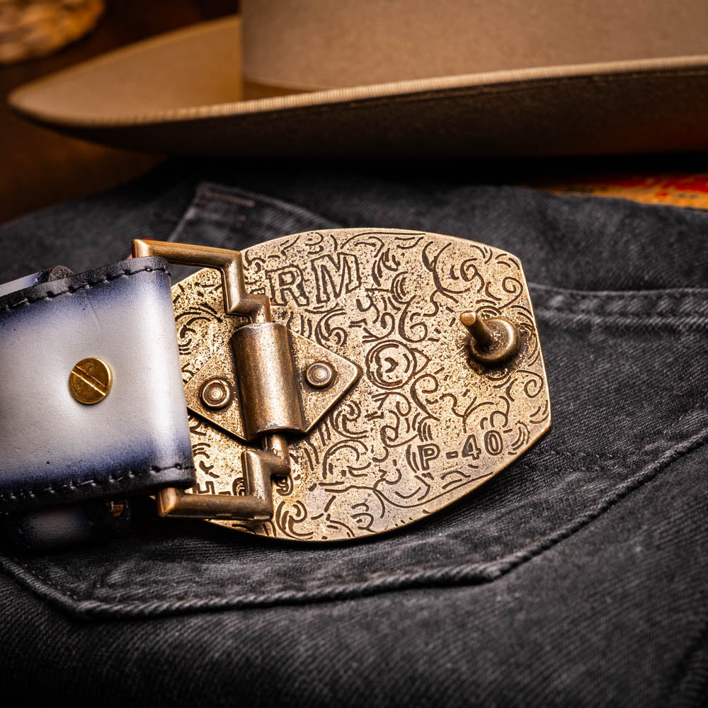 The Montana Belt Stone Gray by Marco Di Milano is a handcrafted leather belt, featuring a gold MD logo buckle and embossed branding on the caiman crocodile strap.