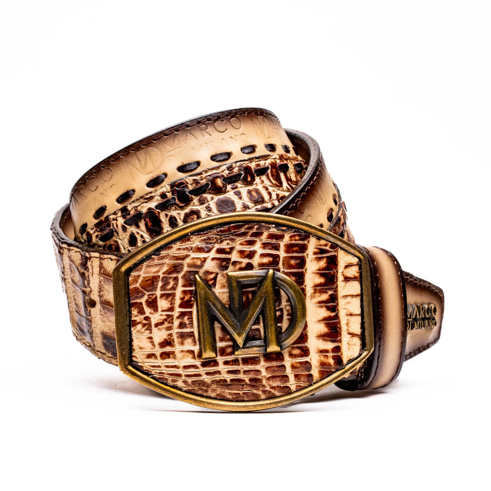 The Montana Belt Stone Orix by Marco Di Milano is a brown handcrafted leather belt with a caiman crocodile pattern and a bold gold MD monogram buckle, elegantly coiled on a white background.