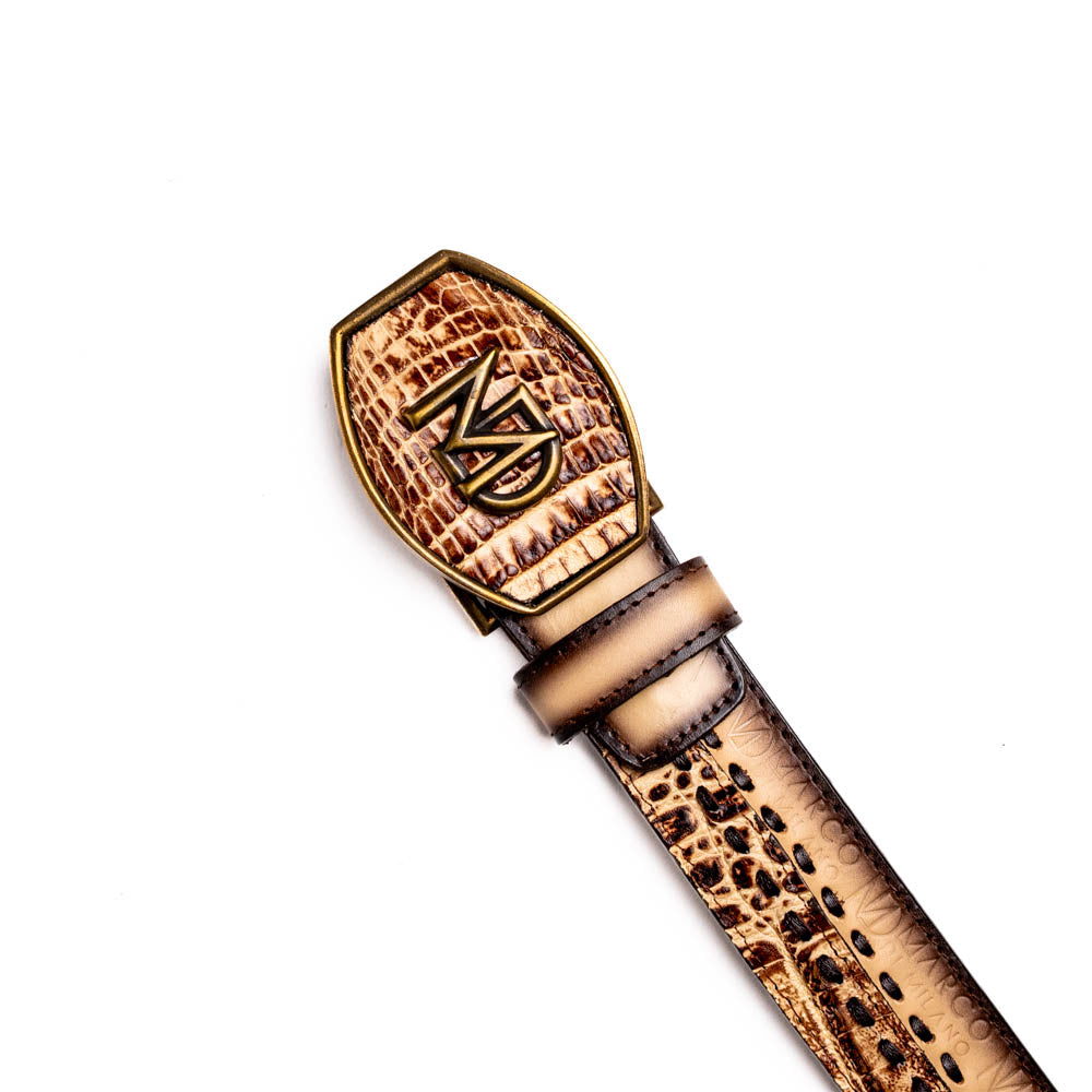 The Montana Belt Stone Orix by Marco Di Milano is a brown handcrafted leather belt with a caiman crocodile pattern and a bold gold MD monogram buckle, elegantly coiled on a white background.