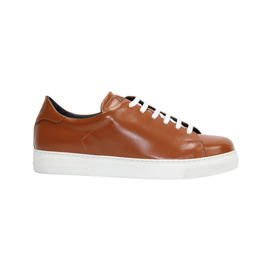 The Duca Monza Ambra by Duca Di Matiste is a brown genuine leather low-top sneaker with white laces and a white rubber sole, displayed in profile on a plain white background—ideal for everyday elegance.