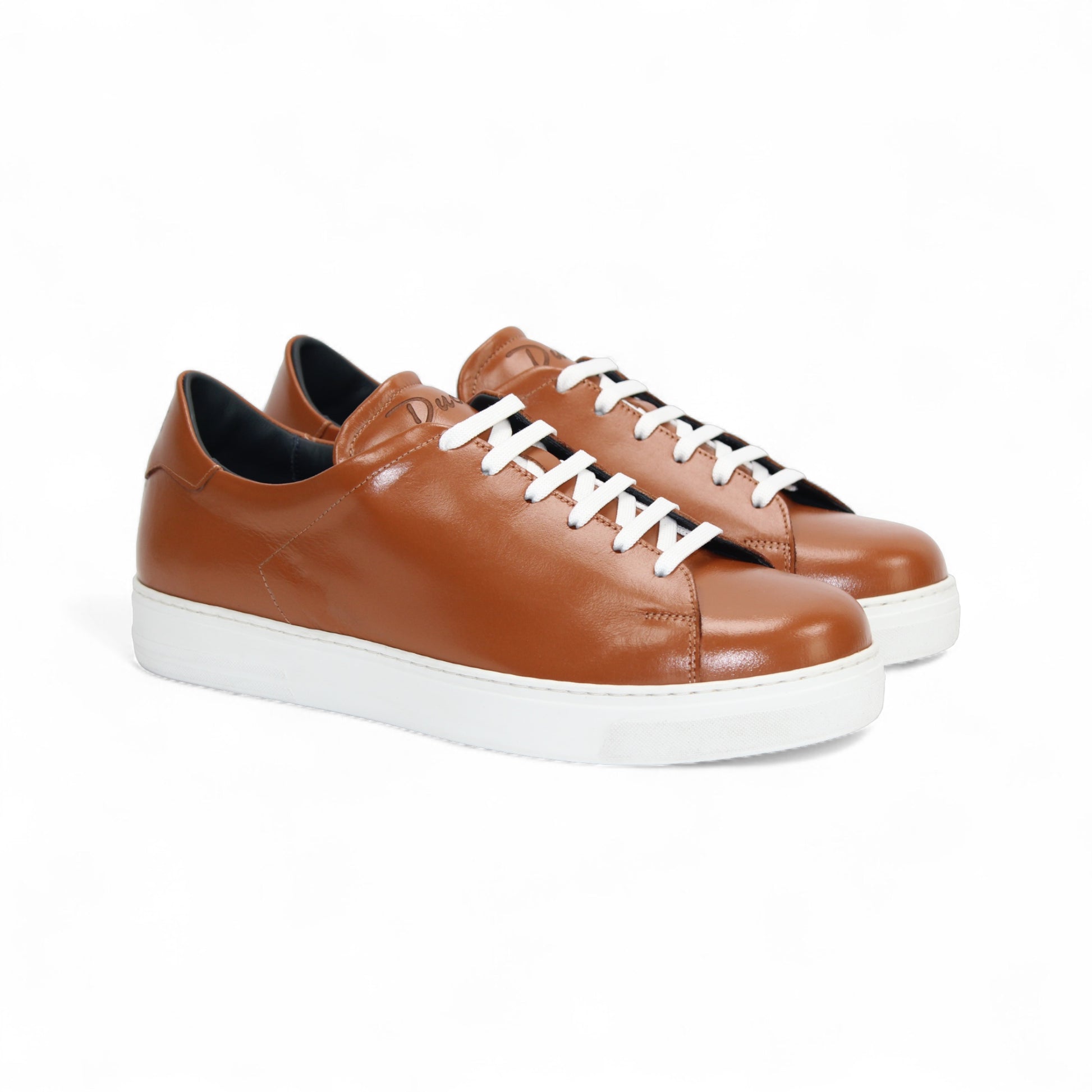 The Duca Monza Ambra by Duca Di Matiste is a brown genuine leather low-top sneaker with white laces and a white rubber sole, displayed in profile on a plain white background—ideal for everyday elegance.