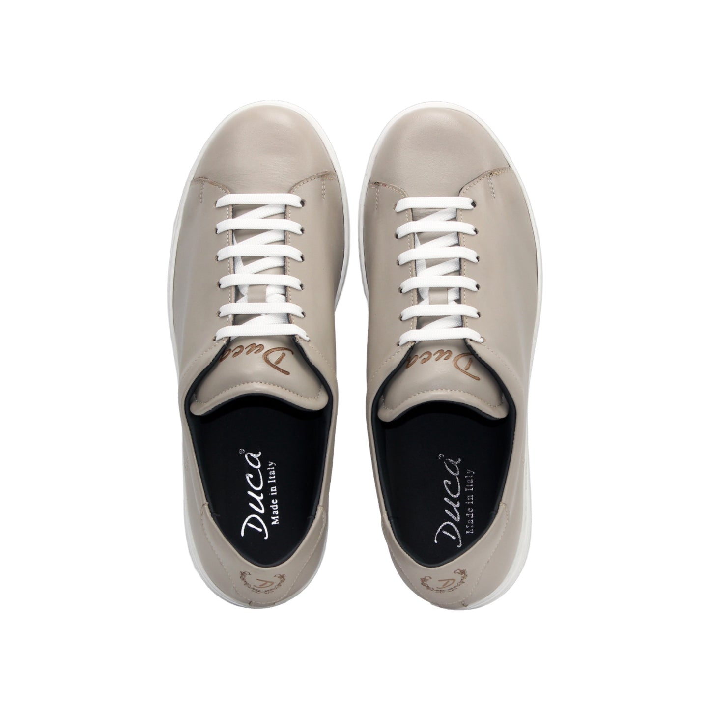 The Duca Di Matiste Duca Monza Grey is a genuine leather low-top sneaker in beige, with white laces and a white sole. Shown from the side on a plain white background, these shoes are perfect for everyday wear.