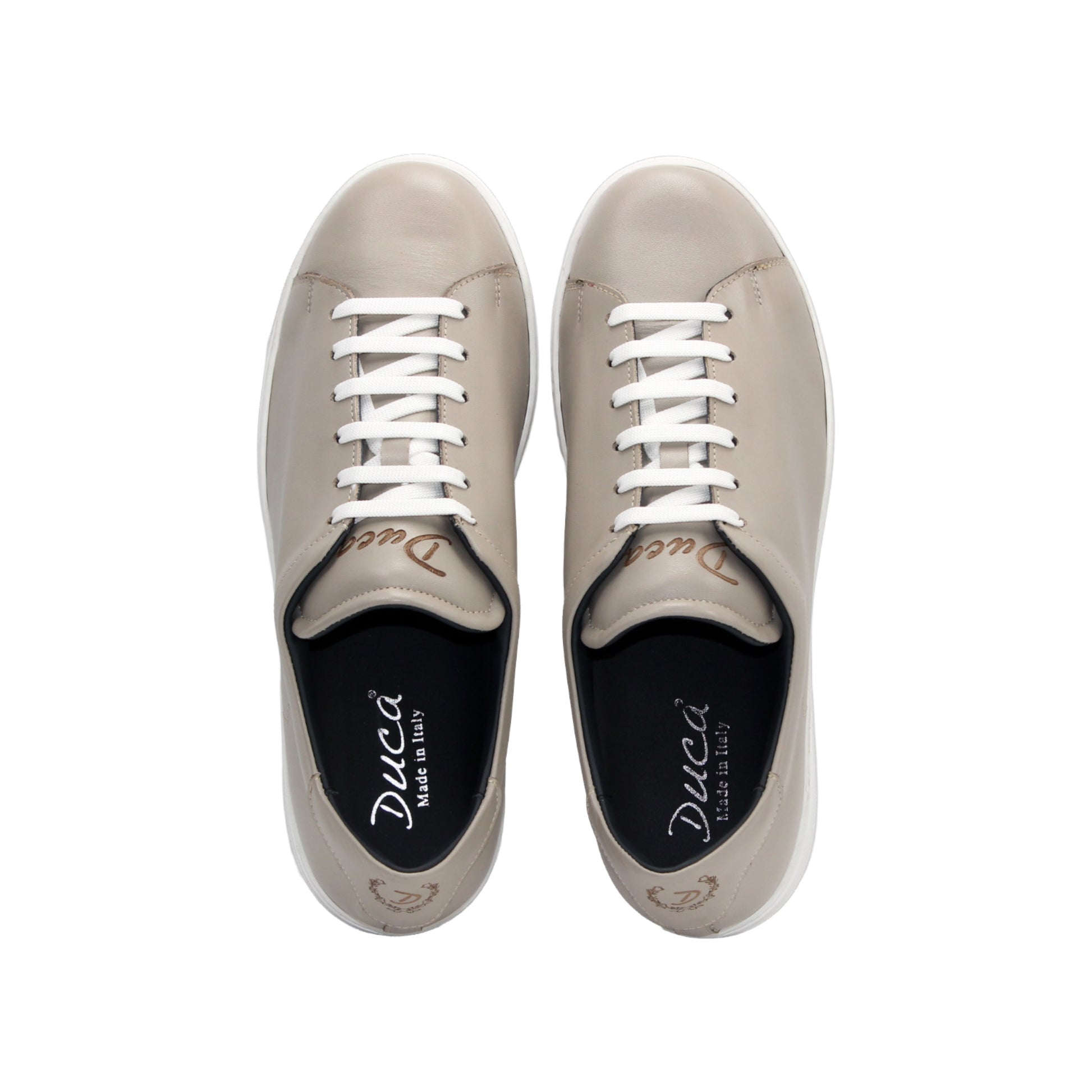 The Duca Di Matiste Duca Monza Grey is a genuine leather low-top sneaker in beige, with white laces and a white sole. Shown from the side on a plain white background, these shoes are perfect for everyday wear.