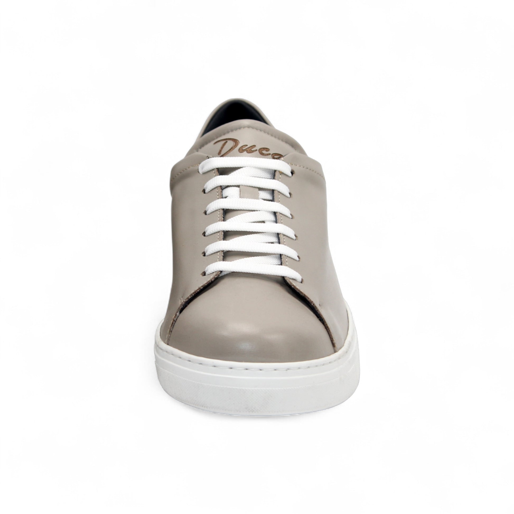 The Duca Di Matiste Duca Monza Grey is a genuine leather low-top sneaker in beige, with white laces and a white sole. Shown from the side on a plain white background, these shoes are perfect for everyday wear.