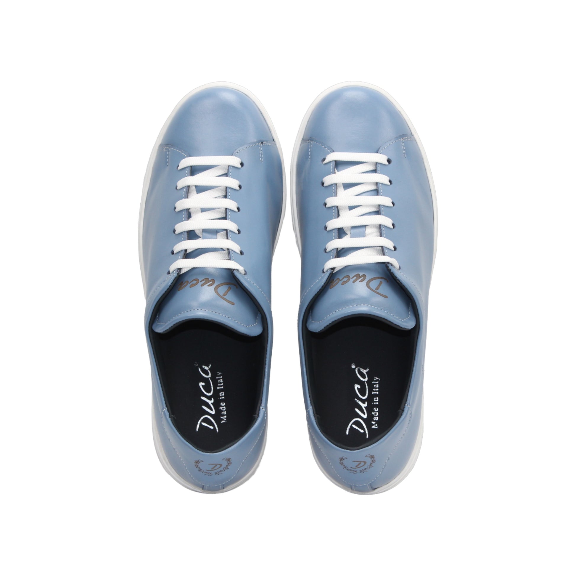 The Duca Monza Light Blue sneaker by Duca Di Matiste features genuine leather in light blue, white laces, and a thick white sole—an effortlessly versatile shoe that highlights Italian craftsmanship, shown in profile on a plain white background.