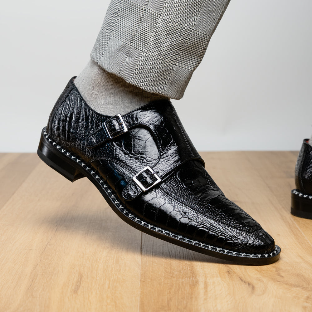 The Marco Di Milano Napoli Black is a pair of genuine ostrich leg dress shoes featuring a textured pattern, double monk strap, and brown branded sole—one shoe upright, the other showing the sole.