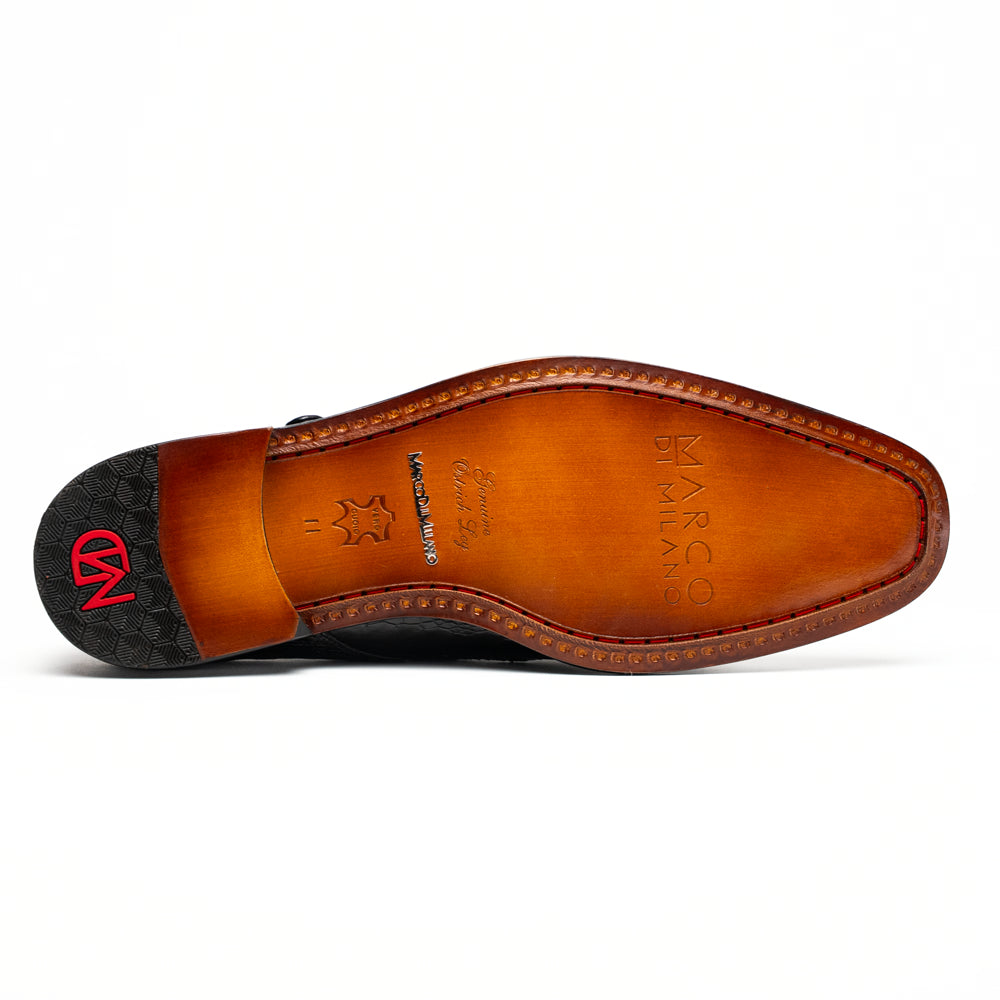 The Marco Di Milano Napoli Black is a pair of genuine ostrich leg dress shoes featuring a textured pattern, double monk strap, and brown branded sole—one shoe upright, the other showing the sole.