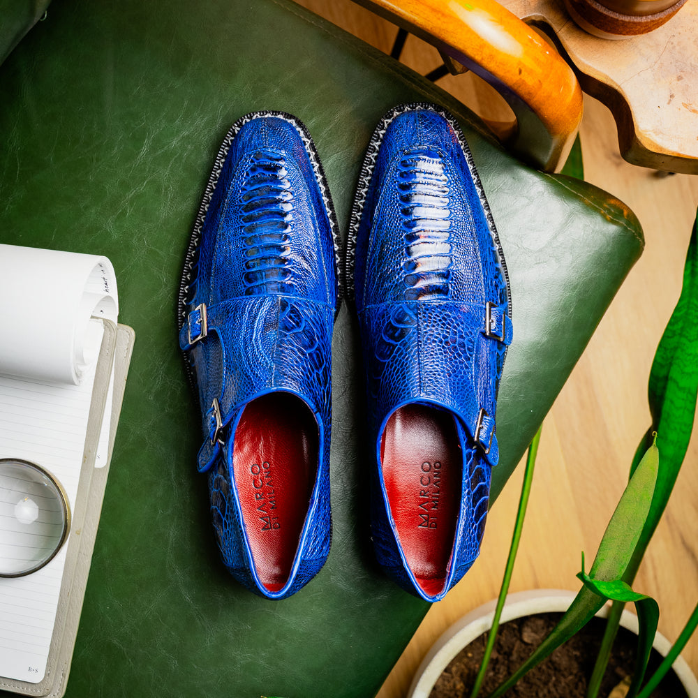The Marco Di Milano Napoli Electric Blue exotic leather double monk strap shoes are shown: one upright and one on its side displaying the sole, set against a white background.