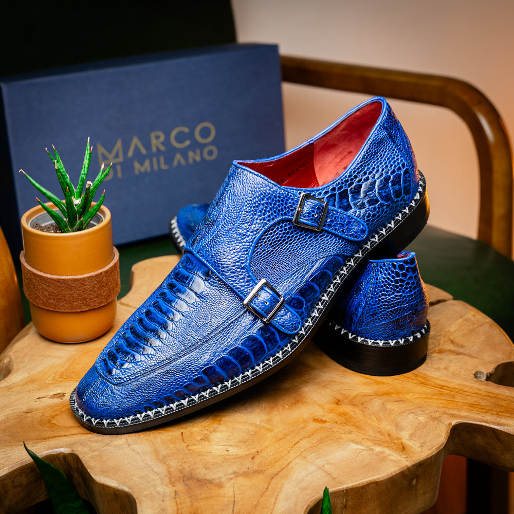 The Marco Di Milano Napoli Electric Blue exotic leather double monk strap shoes are shown: one upright and one on its side displaying the sole, set against a white background.