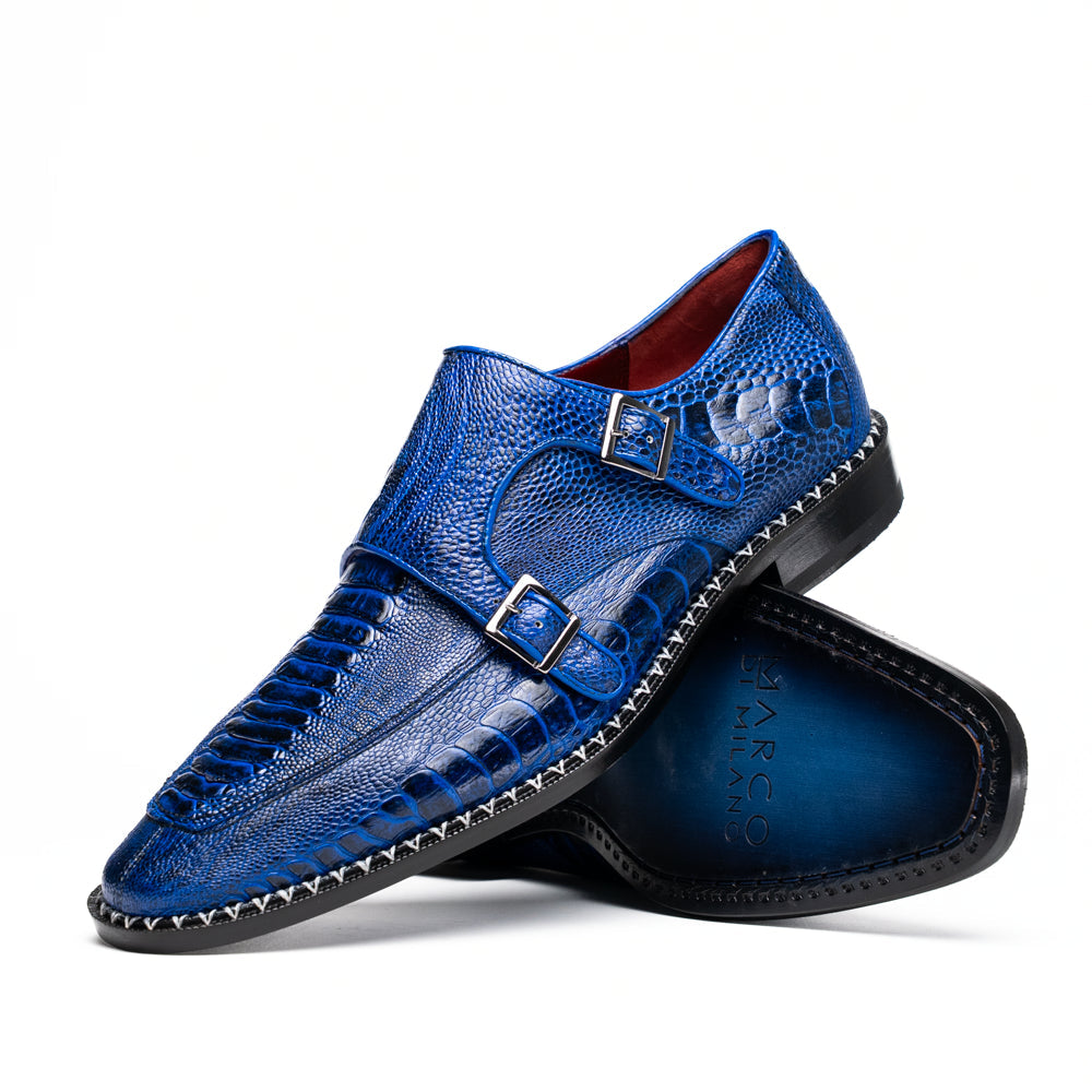 The Marco Di Milano Napoli Electric Blue exotic leather double monk strap shoes are shown: one upright and one on its side displaying the sole, set against a white background.