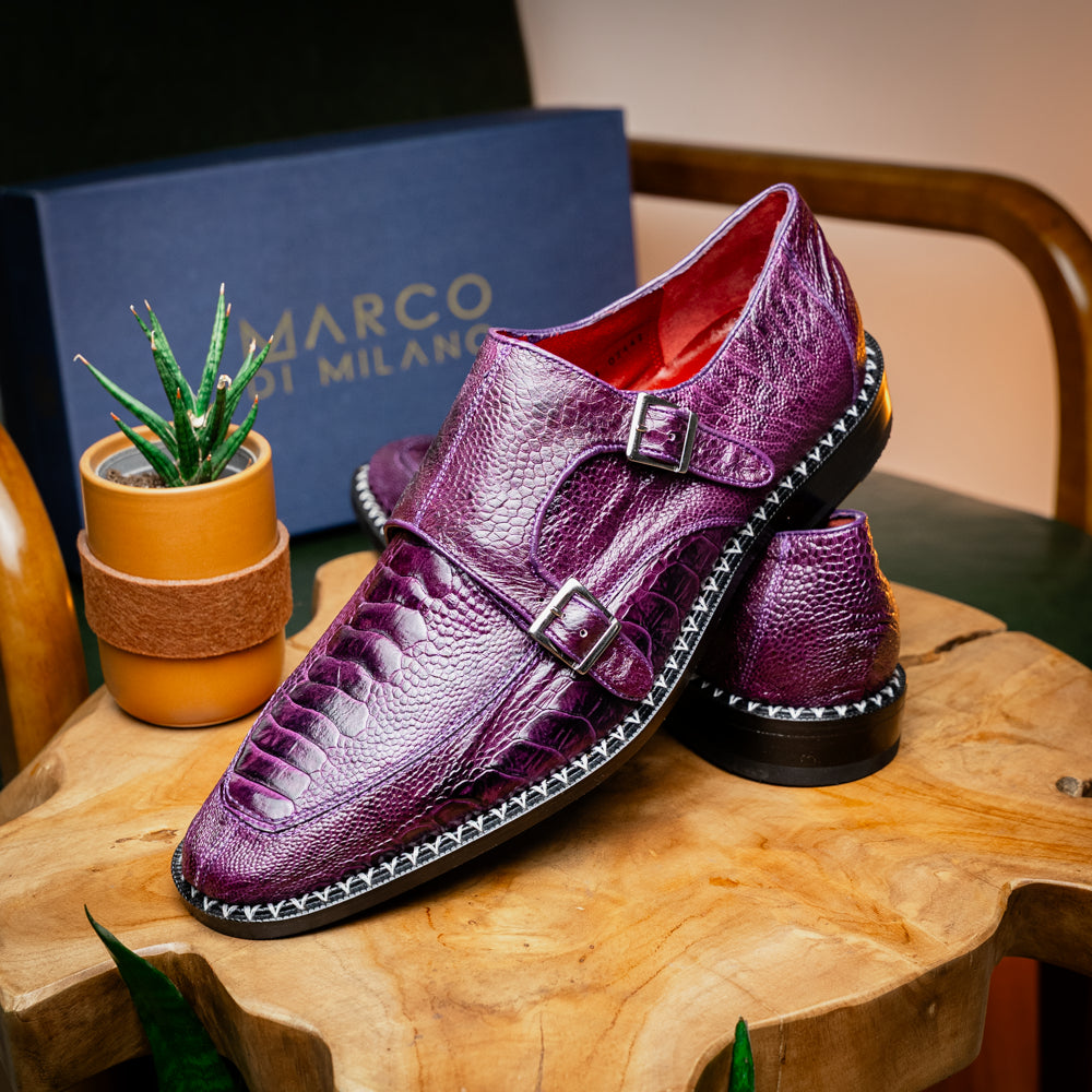 The Marco Di Milano Napoli Purple dress shoes feature genuine ostrich leather, a double monk strap, and textured detailing, with one shoe shown on its side to highlight the sole.