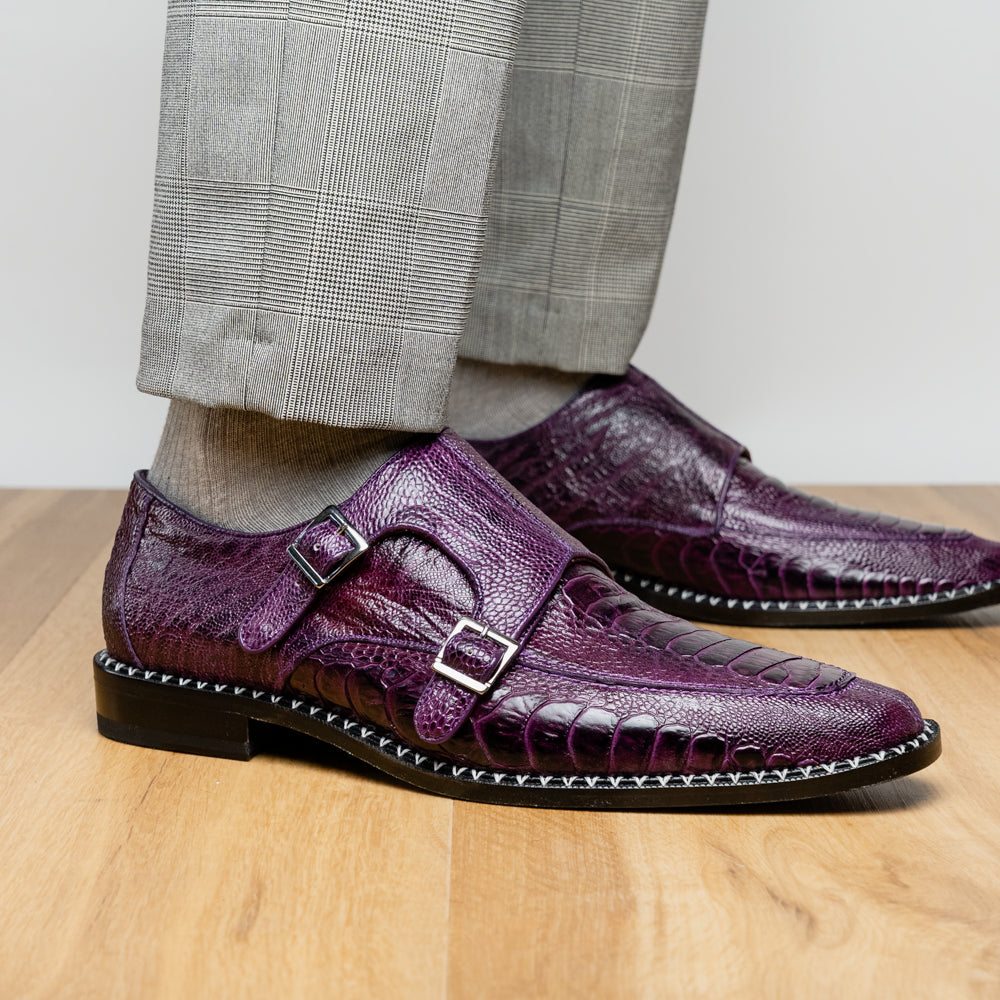 The Marco Di Milano Napoli Purple dress shoes feature genuine ostrich leather, a double monk strap, and textured detailing, with one shoe shown on its side to highlight the sole.